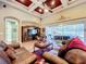 Spacious living room with coffered ceilings, plush seating, and backyard access for indoor-outdoor living at 2805 Ponkan Meadow Dr, Apopka, FL 32712
