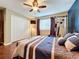 Bedroom featuring hardwood floors, a ceiling fan, and exercise equipment at 2805 Ponkan Meadow Dr, Apopka, FL 32712