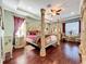 This primary bedroom has a tray ceiling and a decorative four poster bed at 2805 Ponkan Meadow Dr, Apopka, FL 32712