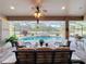 Screened lanai features a beautiful pool with a waterfall, spa, and comfortable seating area at 2805 Ponkan Meadow Dr, Apopka, FL 32712