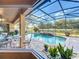 Screened pool with a waterfall feature, surrounded by a brick patio and lush landscaping at 2805 Ponkan Meadow Dr, Apopka, FL 32712