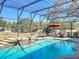 The screened-in pool features a waterfall spa and patio seating for outdoor relaxation at 2805 Ponkan Meadow Dr, Apopka, FL 32712