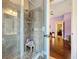 Shower stall with tiled walls and seat near an open door at 2805 Ponkan Meadow Dr, Apopka, FL 32712