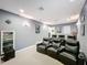 Home theater with reclining chairs, a large screen, and wall-mounted sconces at 2805 Ponkan Meadow Dr, Apopka, FL 32712