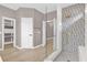 This bathroom features a glass enclosed shower with decorative tile and an open doorway at 2819 Boating Blvd, Kissimmee, FL 34746