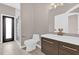 This bathroom has a glass enclosed shower, a dark vanity, a matching mirror, and modern light fixture at 2819 Boating Blvd, Kissimmee, FL 34746