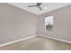 Neutral bedroom featuring hardwood floors, large window with a water view, and a ceiling fan at 2819 Boating Blvd, Kissimmee, FL 34746