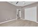 Neutral bedroom with wood-look flooring, ceiling fan, and closet at 2819 Boating Blvd, Kissimmee, FL 34746