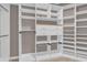 This walk in closet features custom shelving, drawers and metal hanging racks at 2819 Boating Blvd, Kissimmee, FL 34746