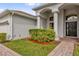 Close up of entryway featuring columns, arched window, brick walkway and manicured landscaping at 2819 Boating Blvd, Kissimmee, FL 34746