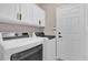 Bright laundry room featuring white cabinets, modern appliances, and a door to the rest of the home at 2819 Boating Blvd, Kissimmee, FL 34746