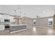 Bright open-concept living room and kitchen with modern appliances and wood-look floors at 2819 Boating Blvd, Kissimmee, FL 34746