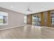 Spacious living room featuring wood-look floors, large windows, and access to the lanai at 2819 Boating Blvd, Kissimmee, FL 34746
