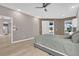Spacious primary bedroom featuring neutral walls, ceiling fan, and sliding doors to lanai at 2819 Boating Blvd, Kissimmee, FL 34746