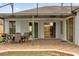 This screened-in patio has brick pavers, an outdoor table, and an outdoor grill at 2819 Boating Blvd, Kissimmee, FL 34746
