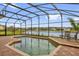 Screened-in pool deck with waterfront views and space for outdoor seating at 2819 Boating Blvd, Kissimmee, FL 34746