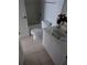 Bright bathroom featuring tile floors, white vanity, and a tub at 2836 Club Cortile Cir, Kissimmee, FL 34746