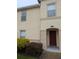 Inviting home exterior featuring a red front door and manicured landscaping at 2836 Club Cortile Cir, Kissimmee, FL 34746