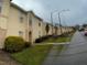 Exterior shot of a well-maintained two-story townhome with neat landscaping at 2836 Club Cortile Cir, Kissimmee, FL 34746