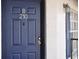 Condo front door in blue with gold hardware and white trim, house number B210 at 3651 N Goldenrod Rd # 210, Winter Park, FL 32792