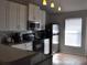 This kitchen has white cabinetry, granite countertops and stainless steel appliances at 3651 N Goldenrod Rd # 210, Winter Park, FL 32792