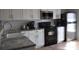 White cabinetry, granite countertops, and stainless steel appliances highlight this modern kitchen at 3651 N Goldenrod Rd # 210, Winter Park, FL 32792