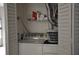This is a laundry room featuring a washer and dryer, and shelf storage at 3651 N Goldenrod Rd # 210, Winter Park, FL 32792