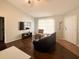 Open-concept living room with a TV, comfortable seating, and bright natural light at 3651 N Goldenrod Rd # 210, Winter Park, FL 32792
