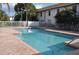 Community pool is surrounded by a fence, brick patio and mature landscaping at 3651 N Goldenrod Rd # 210, Winter Park, FL 32792