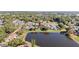 An aerial view shows the community near a scenic pond and lush green spaces at 3967 Campfire Way, Casselberry, FL 32707