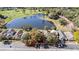 Aerial view of the property, showcasing the surrounding trees, lake, and parking at 3967 Campfire Way, Casselberry, FL 32707