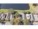 Aerial view of townhomes near a serene pond, showcasing the community's attractive landscaping and convenient parking at 3967 Campfire Way, Casselberry, FL 32707