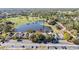 An aerial shot displays townhomes located next to a peaceful pond and scenic green spaces at 3967 Campfire Way, Casselberry, FL 32707