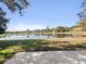 Scenic backyard view with a lake and lush green grass at 3967 Campfire Way, Casselberry, FL 32707