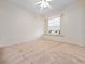 A bright bedroom with a large window and plush carpeting at 3967 Campfire Way, Casselberry, FL 32707