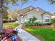 Charming single-story home featuring manicured landscaping and a welcoming walkway leading to the front door at 3967 Campfire Way, Casselberry, FL 32707