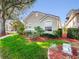 Pleasant home with lush green grass and attractive mulch beds, showcasing a well-cared-for outdoor space at 3967 Campfire Way, Casselberry, FL 32707