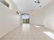 Spacious living area featuring tile floors, high ceilings, and sliding glass doors offering a view of the tranquil lake at 3967 Campfire Way, Casselberry, FL 32707