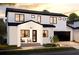 Charming two-story home featuring clean white brick, black accents, and a welcoming front porch at 407 Calhoun Pl, Orlando, FL 32801