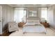 Serene main bedroom featuring soft decor, plush bedding, and natural light from large windows at 407 Calhoun Pl, Orlando, FL 32801