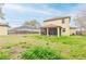 Large backyard featuring a screened-in porch, perfect for outdoor entertaining and relaxation at 410 South Hudson St, Orlando, FL 32835