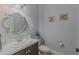 Charming half bathroom featuring nautical décor, a decorative mirror, and vanity with sink at 410 South Hudson St, Orlando, FL 32835