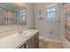 Bathroom featuring a sink, vanity with dark wood cabinets, patterned shower curtain and neutral walls at 410 South Hudson St, Orlando, FL 32835