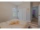 Bright bedroom features a window, closet, and light color palette, creating a cozy and inviting space at 410 South Hudson St, Orlando, FL 32835