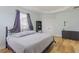 Relaxing bedroom with tray ceiling, wood-look floors, two windows and modern decor at 410 South Hudson St, Orlando, FL 32835