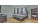Comfortable bedroom with tray ceiling, wood-look floors, two windows and modern decor at 410 South Hudson St, Orlando, FL 32835