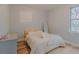 Cozy bedroom with hardwood floors, two windows, closet space, and a comfortable bed at 410 Hudson St, Orlando, FL 32835