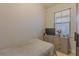 Bedroom featuring neutral walls, wood floor, window with blinds and a dresser with a TV on it at 410 South Hudson St, Orlando, FL 32835