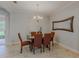Elegant dining room featuring a classic chandelier and ample seating for a perfect dining experience at 410 South Hudson St, Orlando, FL 32835