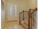 Foyer view showcasing front door, staircase with wooden railings, and tiled floor at 410 South Hudson St, Orlando, FL 32835